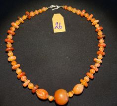 The orange color carnelian stone beads. The origin of this beads from Nepal Himalaya although the carnelian agate can be found in Tibet Pakistan India Nepal and Afghanistan as well.  carnelian agate was used as prayers beads in mala and used as jewelry and amulet as well. old agate and carnelian was used as trade items as well in ancient times.  The age of this beads are more than 600 years.  some gold color brass beads are used as spacers. very smooth and shinny surface of this beads because of Carnelian Orange Amulet Necklace, Orange Carnelian Amulet Necklace, Orange Carnelian Polished Beads Necklace, Orange Carnelian Beads For Spiritual Purposes, Spiritual Orange Carnelian Beaded Necklace, Carnelian Amber Beaded Gemstone Necklace, Hand-strung Orange Carnelian Necklaces, Orange Carnelian Hand-strung Necklace, Amber Carnelian Gemstone Beaded Necklaces