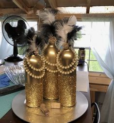 a gold crown sitting on top of a table next to a fan and other items