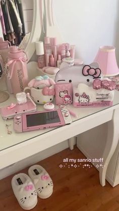 a hello kitty vanity with pink accessories on it's desk and mirror in the background