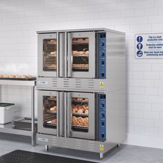 two large ovens with food inside of them in a kitchen next to a counter