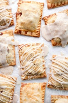 some food is laying out on a white tablecloth and drizzled with icing