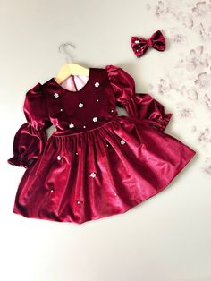 Pearl and shiny stone embroidered burgundy velvet dress offers your baby elegance and comfort together. You will be amazed by the hand-embroidered details on the highest quality velvet fabric with its soft texture and eye-catching color. -The dress is lined with 100% cotton fabric. -Invisible long zipper allows easy dressing -It has long ties extending from both sides of the waist. These ties provide a customizable fit and are ideal for growing children. -It is a perfect fit. You can choose the Velvet Baby Dress, Weihnachten Outfit, Burgundy Velvet Dress, Embroidered Velvet, Baby Christmas Outfit, Baby Christmas, Handmade Baby, Christmas Baby