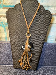 This gorgeous piece ties so you can have it as long as 15 inches or way up high. It is a gorgeous piece. I made one similar to keep for myself and I get compliments everywhere I go on it. The tassel part measures approximately 6 inches long. You will definitely not be disappointed with this gorgeous piece. Adjustable Brown Necklace With Black Beads, Adjustable Long Necklace With Black Beads, Black Bohemian Lariat Necklace, Elegant Adjustable Brown Long Necklace, Everywhere I Go, White Onyx, Hand Beading, Go On, Body Jewelry