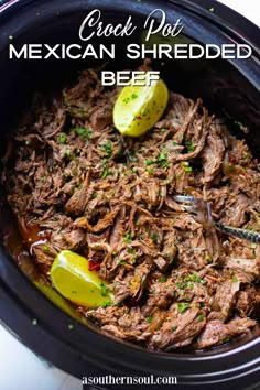 crock pot mexican shredded beef in a slow cooker with limes on the side