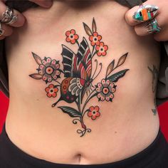 a close up of a woman's stomach with flowers on it