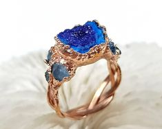 DETAILS  ★ US size: 7 3/4; ★ British: P 1/2; ★ Inside diameter: 17.97mm; ★ Inside circumference: 56.45mm; ★ Azurite crystal cluster ★ Special braided ring band ★ Electroformed and electroplated with copper ★ Naturally oxidized ★ Coated with protective lacquer to protect patina layer and to reduce chance of finger staining (green fingers) ★ What you see is what you get ★ International Shipping available worldwide! ★ Gift ready packaging Electroformed Jewelry is the combination of art and science. Unique Handmade Blue Topaz Ring, Handmade Unique Blue Topaz Ring, Unique Blue Birthstone Rings, Unique Blue Sapphire Gemstone Ring, Unique Blue Crystal Promise Ring, Blue Sapphire Unique Promise Ring, Unique Blue Sapphire Promise Ring, Unique Blue Crystal Round Ring, Handmade Aquamarine Blue Rings