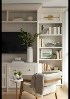 a living room filled with furniture and a flat screen tv on top of a book shelf