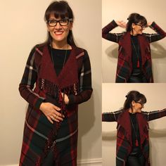 a woman wearing glasses and a red plaid scarf over her shoulders is smiling at the camera while standing in front of a wall