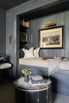 a living room filled with furniture and bookshelves next to a couch in front of a window