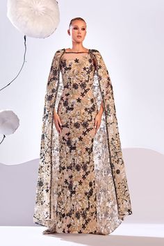 Description Gold Column, Long dress Sleeveless Closed neckline Embroidered lace Modifications Accepted Custom Measurements Accepted Dry Clean Evening Dress Made in Lebanon 873 Embroidered Formal Dress With Cape Sleeves, Evening Dress With Embroidery And Cape Sleeves, Evening Dress With Embroidered Cape Sleeves, Embroidered Evening Dress With Cape Sleeves, Elegant Gown With Intricate Embroidery And Cape Sleeves, Luxury Floral Embroidery Dress For Gala, Party Dress With Intricate Embroidery And Cape Sleeves, Floor-length Dresses With Sheer Sleeves For Reception, Evening Cape Dress With Embroidery