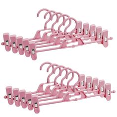 two pink clothes hangers with clips on them