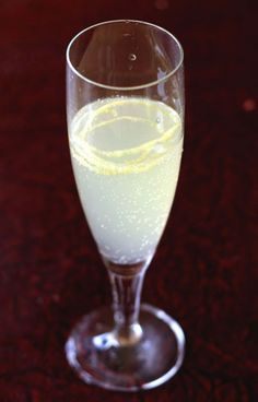 a glass filled with liquid sitting on top of a table