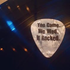 a guitar picker with the words you came we wed it rocked on it's side