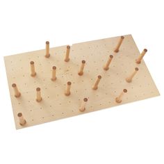 a wooden peg board with several pieces of wood stuck in the pegs on it