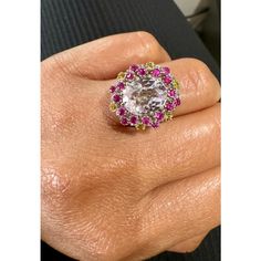 4.94 Carat Kunzite Pink Yellow Sapphire White Gold Cocktail Ring  This beautiful ring has an Oval Cut 3.81 carat Kunzite that is set in the center of the ring and is surrounded by 24 Round Cut Pink and Yellow Sapphires that weigh 1.13 carats. The total carat weight of the ring is 4.94 carats. The Kunzite measures at 9 mm x 11 mm.  The ring is made in 14K White Gold and weighs approximately 6.6 grams.   Exact dimensions for this item are unknown. Please reach out in the seller Q&A for any questio Luxury Round Cut Gemstones With Center Stone, Luxury Round Cut Center Stone Gemstones, Formal Multi-stone Cubic Zirconia Gemstones, Luxury Multi-stone Crystal Ring, Luxury Oval Cubic Zirconia Gemstones, Luxury Multi-stone White Gold Topaz Ring, Luxury Diamond Multi-stone Topaz Ring, Luxury White Gold Multi-stone Topaz Ring, Luxury Multi-stone Diamond Topaz Ring