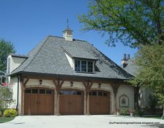 a two car garage with an attached porch