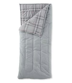 the grey and pink plaid comforter is folded up on a white surface with a gray pillow