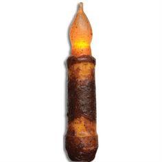 a lit candle that is brown and orange