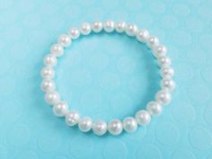 Genuine cultured freshwater pearl bracelet,bridesmaid gift Pearl size:7-8mm pearl shape:near round Color: creamy white Pearl luster: Good Pearl nacre: very thick Elastic pearl bracelet This is a perfect gift for birthday , wedding... in the very attractive price. Please let me know what you want to say on the note card Dear pearl lovers, all pearls in Pearl Select are 100% Real Genuine Cultured freshwater pearls We do not sell faux pearls,imitation pearl,fake pearls,swarovski pearls. Thank you s Pearl Bracelet Bridesmaid Gift, Pearl White Bridesmaid Pearl Bracelet, Pearl White Beaded Pearl Bracelets For Bridesmaids, Hypoallergenic White Bracelet For Bridesmaids, Hypoallergenic White Bracelets As Bridesmaid Gifts, White Pearl Charm Bracelet For First Communion, White Beaded Bracelets With Pearl Charm For Bridesmaids, White Hypoallergenic Pearl Bracelet For First Communion, Hypoallergenic White Pearl Bracelet For First Communion