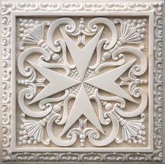 a white tile with an intricate design on it