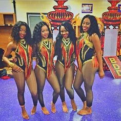 four women in bodysuits are posing for a photo on the dancefloor