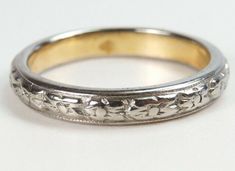 an antique wedding band is shown on a white surface