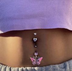 a woman's stomach with a pink butterfly and crystal beads on the bottom part