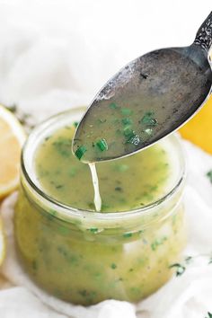 a spoon full of broccoli sauce with lemons in the background