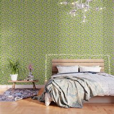 a bedroom with green wallpaper and a bed in the middle, next to a rug