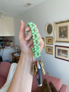 a person holding up some keys in their hand