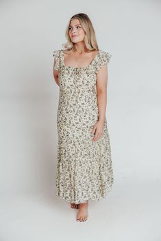 Whether you're frolicking through a field of wildflowers, touring a sunny Greek isle, or attending a springtime baby shower, the Emery Midi Dress will ensure you do it looking like a goddess. We designed this premium dress with an ultra-flattering neckline and a figure-skimming silhouette, paired with a flounced skirt and sweet ruffle details. The Emery is guaranteed to be one of your most feminine (and most favorite!) pieces. FIT: Runs very fitted. This dress is designed with a fit-and-flare profile, and is fitted through the waist and hips. Fabric does not stretch, so we recommend sizing up if you are in mid-to-late maternity. MATERIAL: Self: 75% Rayon, 25% Nylon; Lining: 100% Cotton. GARMENT DETAILS: Lightweight summer dress in a long midi length and charming vintage silver print chiffo Cottagecore Flowy Maxi Dress For Garden Party, Spring Ruffled Maxi Dress For Gatherings, Bohemian Short Sleeve Dress For Picnic, Fitted Boho Dress With Boho Print For Garden Party, Bohemian Ditsy Floral Print Maxi Dress For Spring, Spring Bohemian Maxi Dress With Ditsy Floral Print, Bohemian Maxi Dress With Ditsy Floral Print For Spring, Fitted Printed Boho Dress For Spring, Cottagecore Flowy Midi Dress For Garden Party