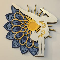 a paper cut out of a woman's body on top of a blue and yellow flower