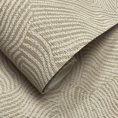 a beige and white wallpaper with wavy lines on the fabric, as well as a roll of tape