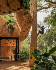 a person on a rope in the middle of a room with wooden floors and walls