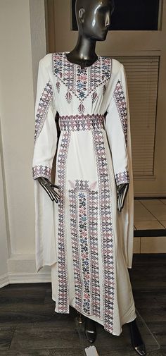 An Elegant White Jordanian Palestinian Thobe Dress Kaftan Abaya with Purple, Pink and light blue Embroidery tatreez from the front, over skirt on the waist and embroidered cape on both shoulders comes with a belt Embroidery Details are on the front, the shoulders cape and belt as shown in the pictures & Video. Comes with a lining dress (Long sleeves white under dress) Modern Design, Very high quality Materials. always the product in real much prettier than the picture. - Color : White & Purple, pink and light blue embroidery Size 3((Fits Medium & Large Size)) Bust : 44 inches Shoulders : 18-20 inches Length : 58 inches. Half Sleeves  Long Sleeve Under Dress - Condition : NEW - Price : 260$ - Shipping : Free Shipping with USPS Priority Mail Shipping  - No Returns & No Exchange Accepted plea Embroidery Abaya Design, Long Sleeve Under Dress, Uae Abaya, Jordanian Dress, National Day Uae, Belt Embroidery, Light Blue Embroidery, Embroidery Abaya, Stylish Abaya