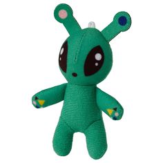 a green stuffed animal with big eyes and ears on it's head, sitting in front of a white background