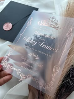 a person holding up a wedding card in front of an envelope with the word happy frances on it