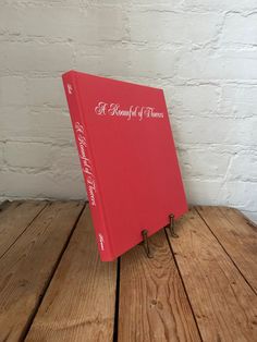 a red book sitting on top of a wooden table