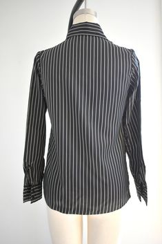 "Description: 1970s black and white striped silky polyester blouse. Long sleeves with pleated shoulders. Button front. Condition: In great condition, with no holes or stains. Designer: It's Gailord Stated Size: 10 Measurements: Armpit to armpit: 18\" Shoulder to shoulder: 14.5\" Sleeve length: 23\" Overall length: 23\" Waist: up to 35\" ---> If you need an order shipped by a particular date or shipped via a quicker method, please ask PRIOR to purchase to see if we can accommodate that request 1970s Black And White, Polyester Blouse, Womens Blouses, Striped Blouse, Liz Claiborne, Shoulder To Shoulder, May 2024, White Stripe, Vintage Outfits