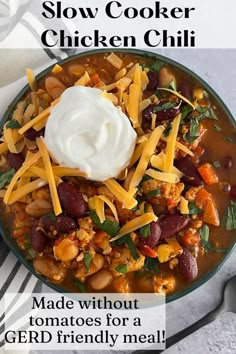 a bowl filled with stew and topped with sour cream