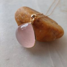 **Pendant ready for dispatch i.e. no processing time** **Pendant shown in the picture is available** Details of the pendants: Rose Quartz Pendant Stone Weight: 29.20 carats Stone size and shape: 20x21 mm & Pear Metal: GOLD Purity: 14K (58.33%) approx Gold Weight: 0.71 grams Gross Weight: 6.55 grams Rose Quartz necklace pendant. These pendants are absolutely perfect for daily wear as they are light and definitely stylish. This dainty pendant can be used in layers with other pendants. The init Pink Jewerly, Rose Quartz Necklace Pendants, Rose Quartz Jewelry, Glass Beads Jewelry, Dainty Pendant, Rose Quartz Pendant, Rose Quartz Necklace, Quartz Jewelry, Bezel Pendant