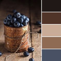 a jar filled with blueberries sitting on top of a wooden table