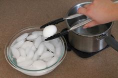 someone is cutting marshmallows into small pieces in a bowl on the counter