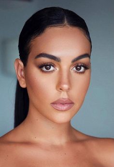 an image of a woman with makeup on her face and brown eyeshadow, looking at the camera