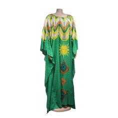 Add a touch of African fashion to your wardrobe with our gorgeous maxi dresses! These dresses feature oversized designs and beautiful African lace that are perfect for any occasion. Elegant Green Beach Cover-up Dress, Floor-length Maxi Dress For Beach Cover-up, Green Printed Long Dress, Beach Cover-up Maxi Dress, Green Bohemian Maxi Dress, Green Bohemian Printed Maxi Dress, Summer Printed Long Maxi Dress, Green Printed Maxi Dress For Party, Long Printed Maxi Dress For Summer