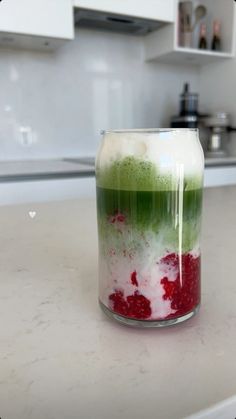 a jar filled with liquid sitting on top of a counter next to a stovetop