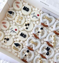 a box filled with white and black decorated cookies