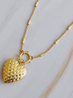 Add a touch of edge to your style with the Patterned Heart Open Locket Necklace. The intricate design pairs perfectly with the delicate heart locket, creating a one-of-a-kind accessory. Ideal for any occasion, the dainty chain adds a subtle touch. Color: Gold Made of: 18k gold plated brass, Lead and nickel-free Brand: Ellison and Young Includes: x1 Necklace Length: Approximately 16" with a 2" extender Elegant Heart Pendant Locket Necklace With Adjustable Chain, Elegant Double Heart Necklace With Lobster Clasp, Elegant Heart Pendant Locket Necklace In Metal, Elegant Heart Locket Necklace With Adjustable Chain, Elegant Heart Pendant Locket Necklace, Elegant Metal Heart Pendant Locket Necklace, Elegant Heart Necklace With Lobster Clasp For Anniversary, Elegant Gold Heart Locket Necklace, Elegant Metal Locket Necklace For Valentine's Day