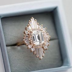 an engagement ring in a box with diamonds