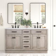 a bathroom with double sinks and mirrors on the wall